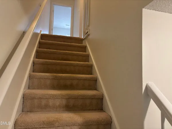 a view of staircase with empty racks