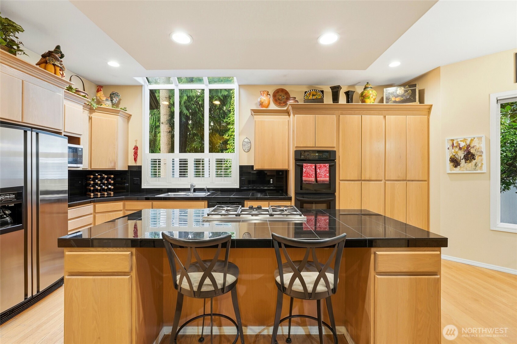 5633 194th Lane Southeast Issaquah, WA 98027 - Photo 14 of 40 a kitchen with stainless steel appliances granite countertop a stove and a refrigerator