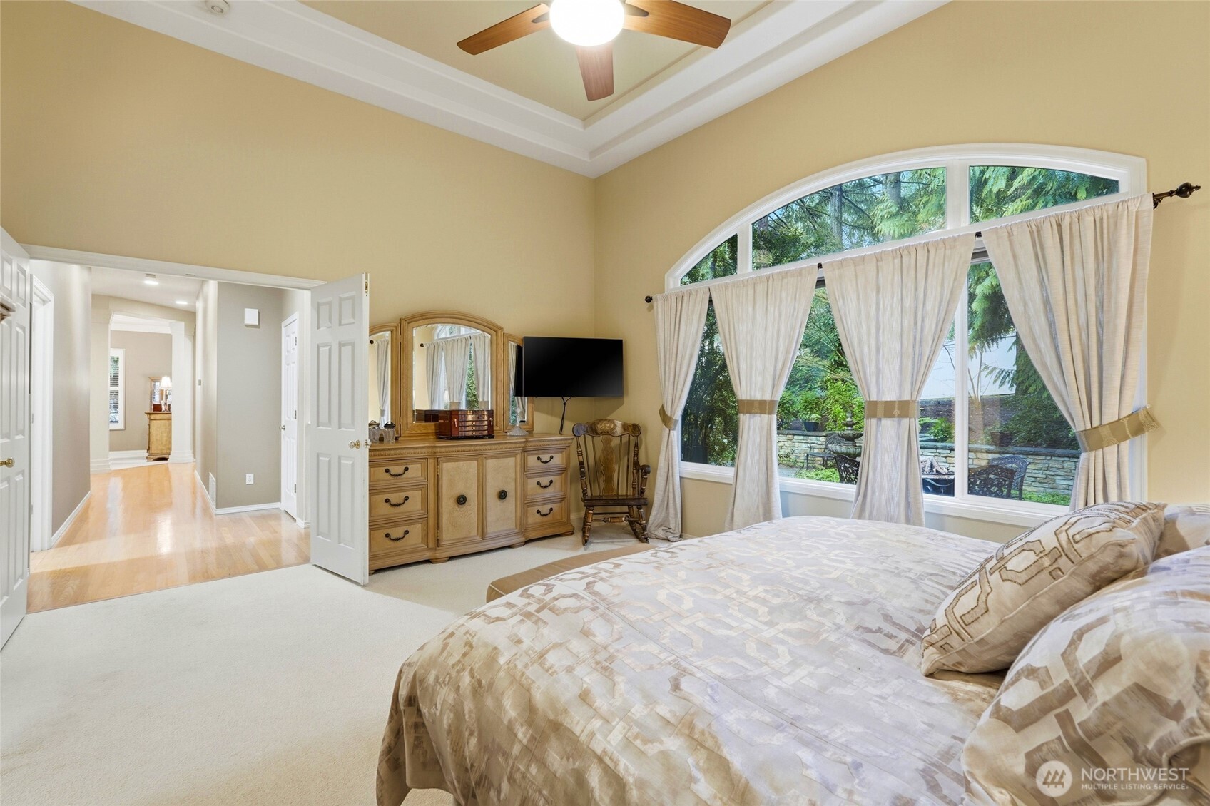 5633 194th Lane Southeast Issaquah, WA 98027 - Photo 24 of 40 a bedroom with a bed and a flat tv screen on dresser