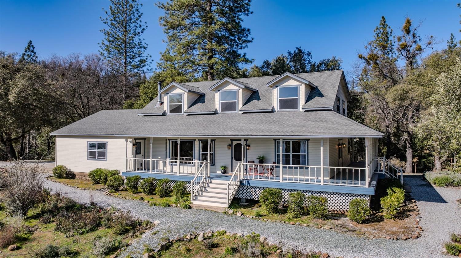 a front view of a house with a yard table and chairs