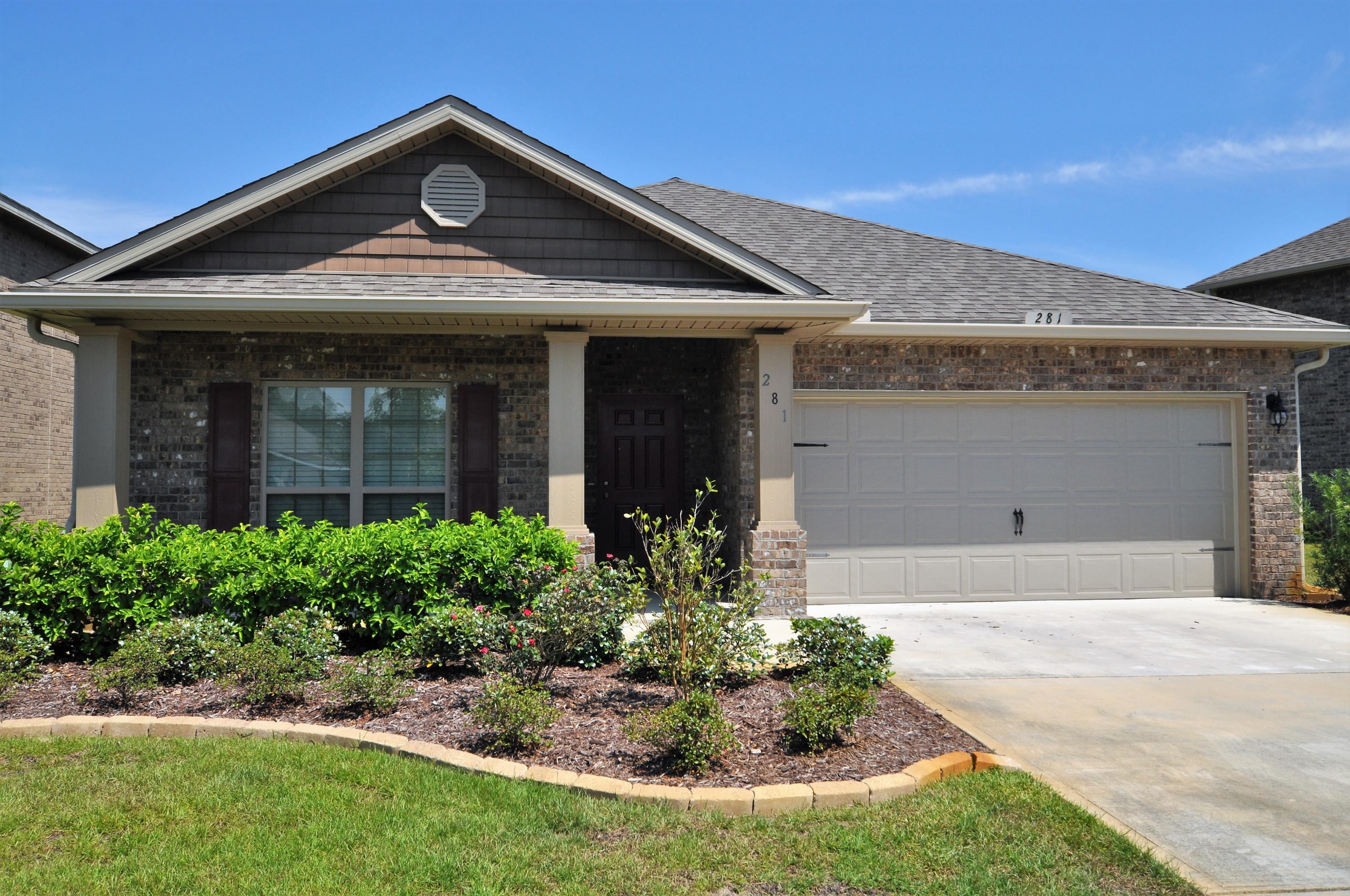 281 Pin Oak Loop Santa Rosa Beach, FL 32459 - Photo 1 of 21 a front view of a house with garden