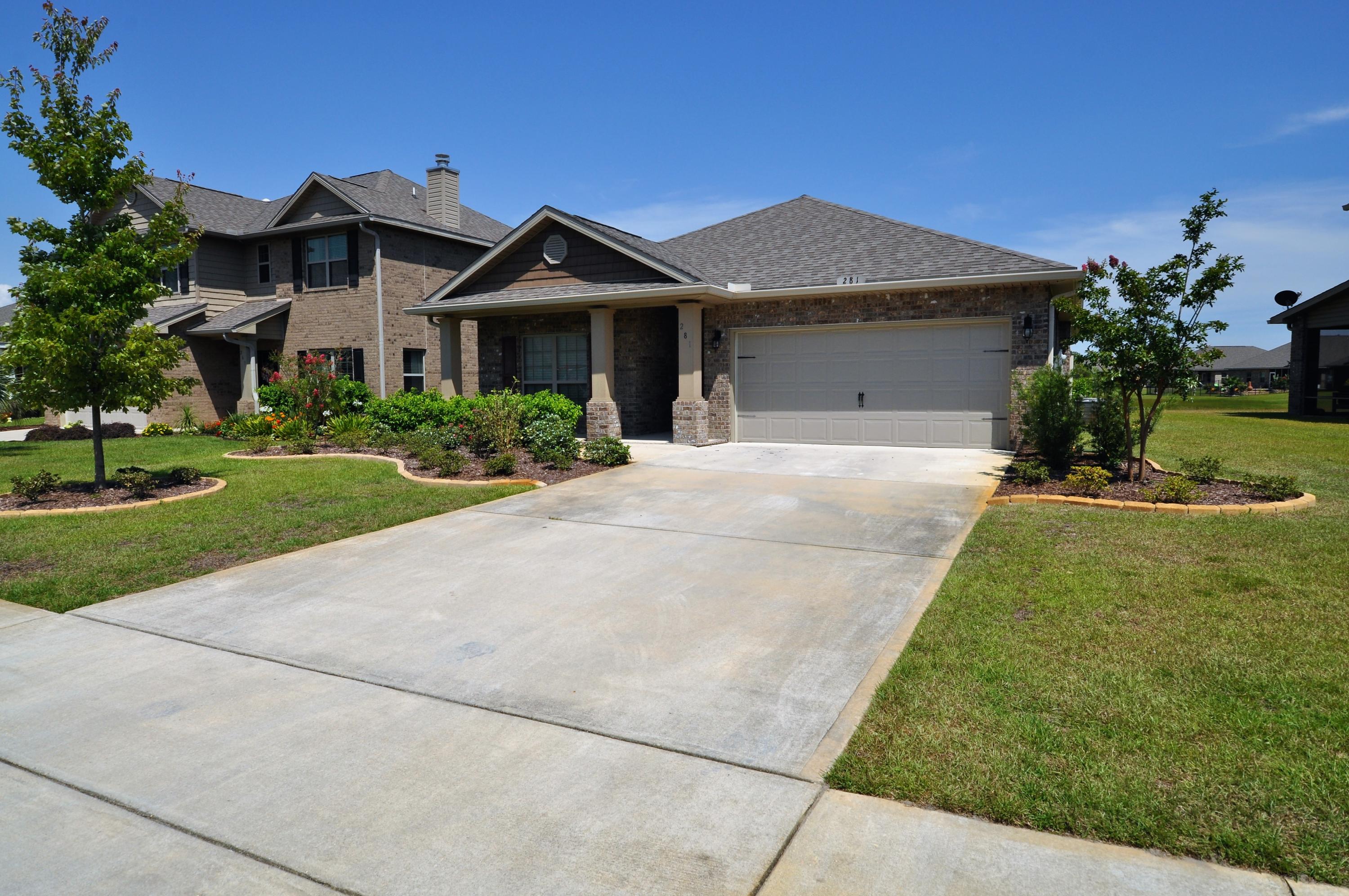 281 Pin Oak Loop Santa Rosa Beach, FL 32459 - Photo 2 of 21 a front view of a house with a yard