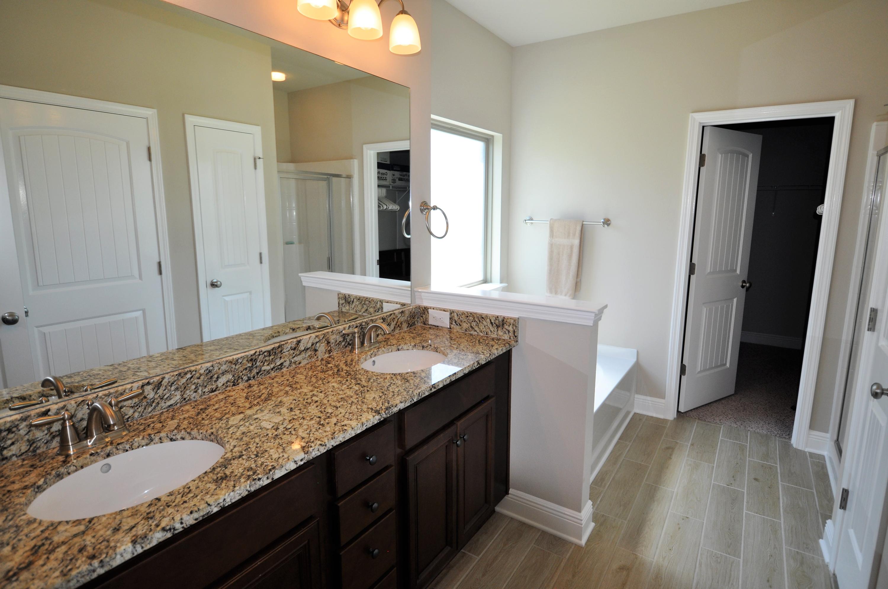 281 Pin Oak Loop Santa Rosa Beach, FL 32459 - Photo 11 of 21 a bathroom with a granite countertop sink and a mirror