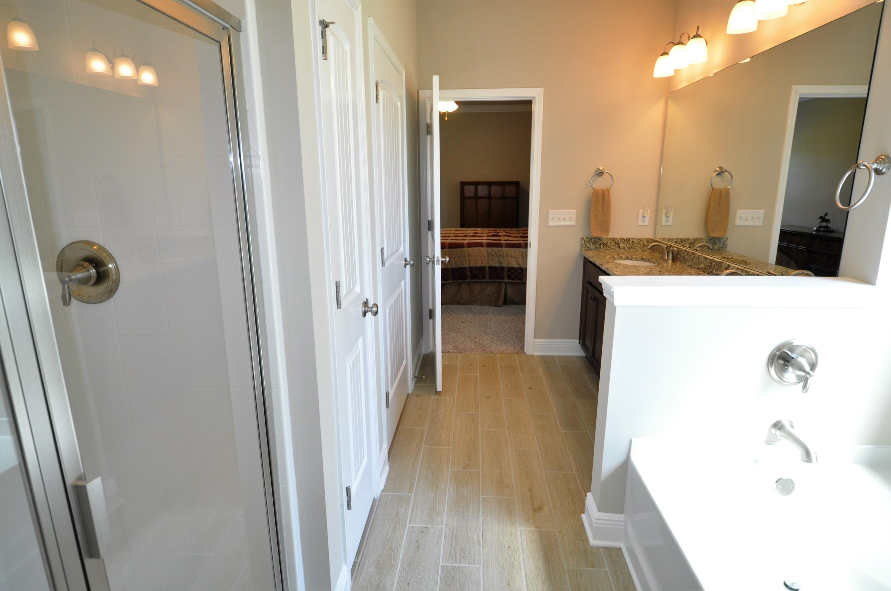 281 Pin Oak Loop Santa Rosa Beach, FL 32459 - Photo 12 of 21 a bathroom with a tub sink and mirror