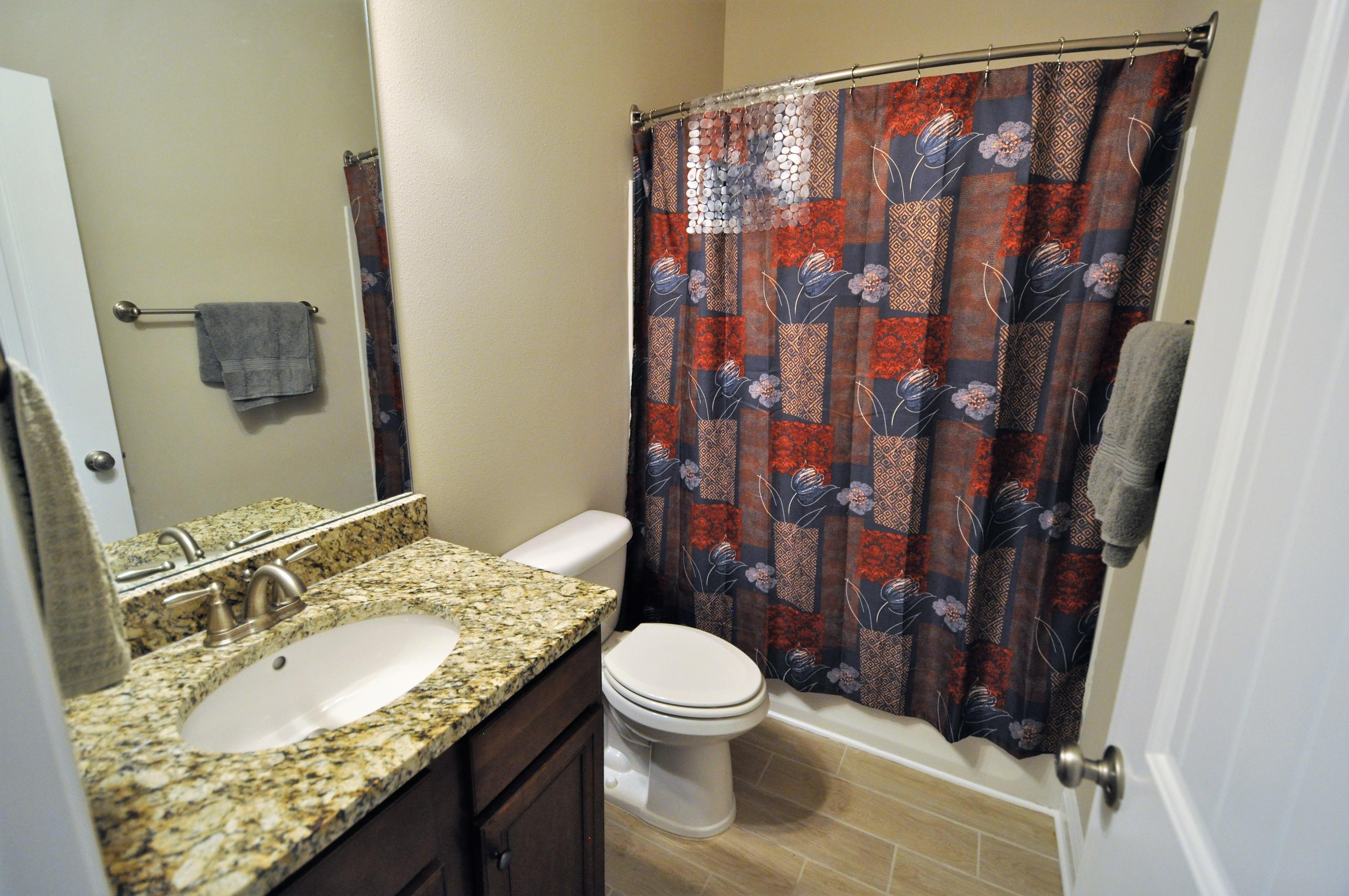 281 Pin Oak Loop Santa Rosa Beach, FL 32459 - Photo 14 of 21 a bathroom with a granite countertop sink toilet and shower