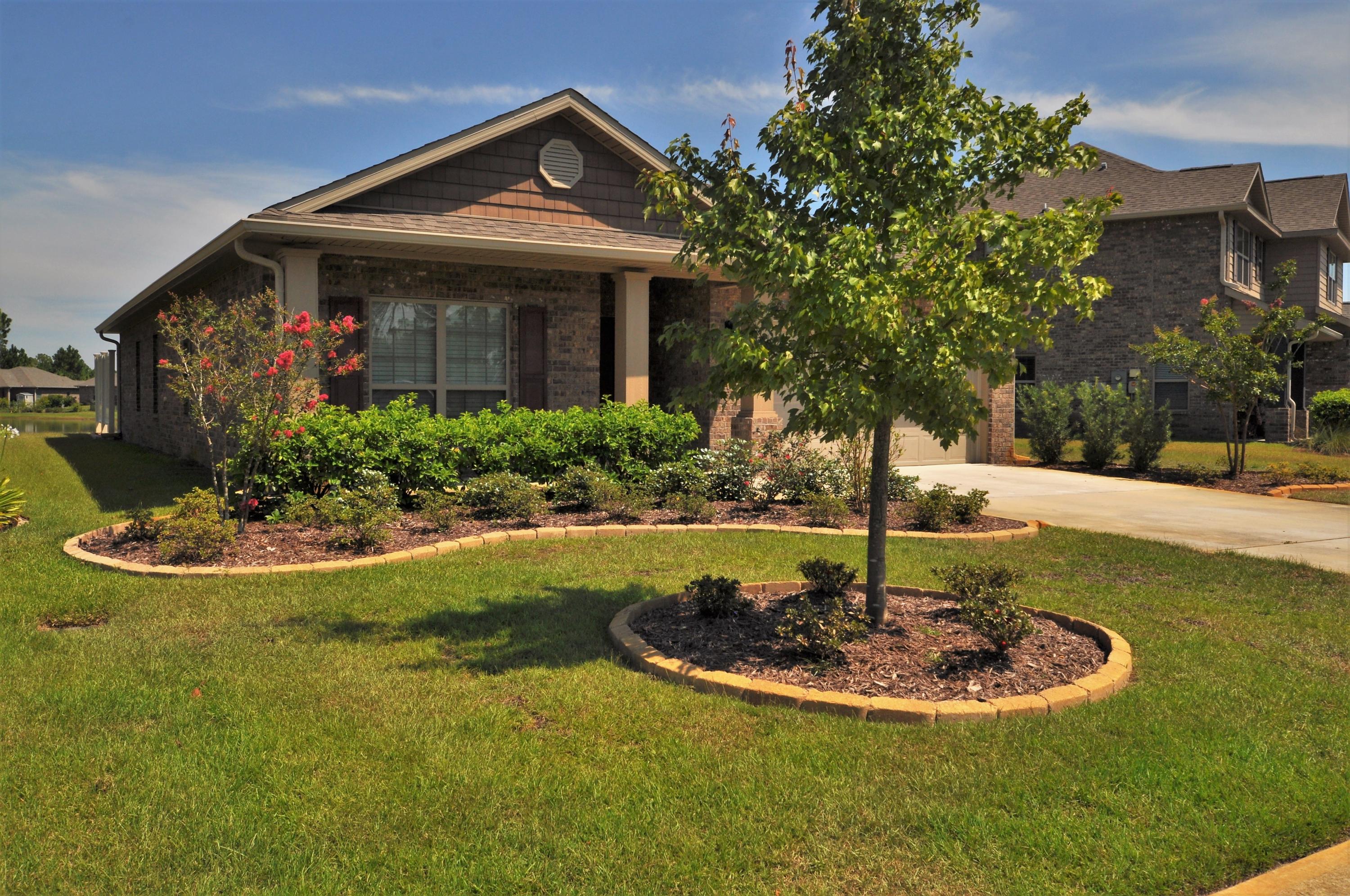 281 Pin Oak Loop Santa Rosa Beach, FL 32459 - Photo 3 of 21 a view of a house with swimming pool and a yard