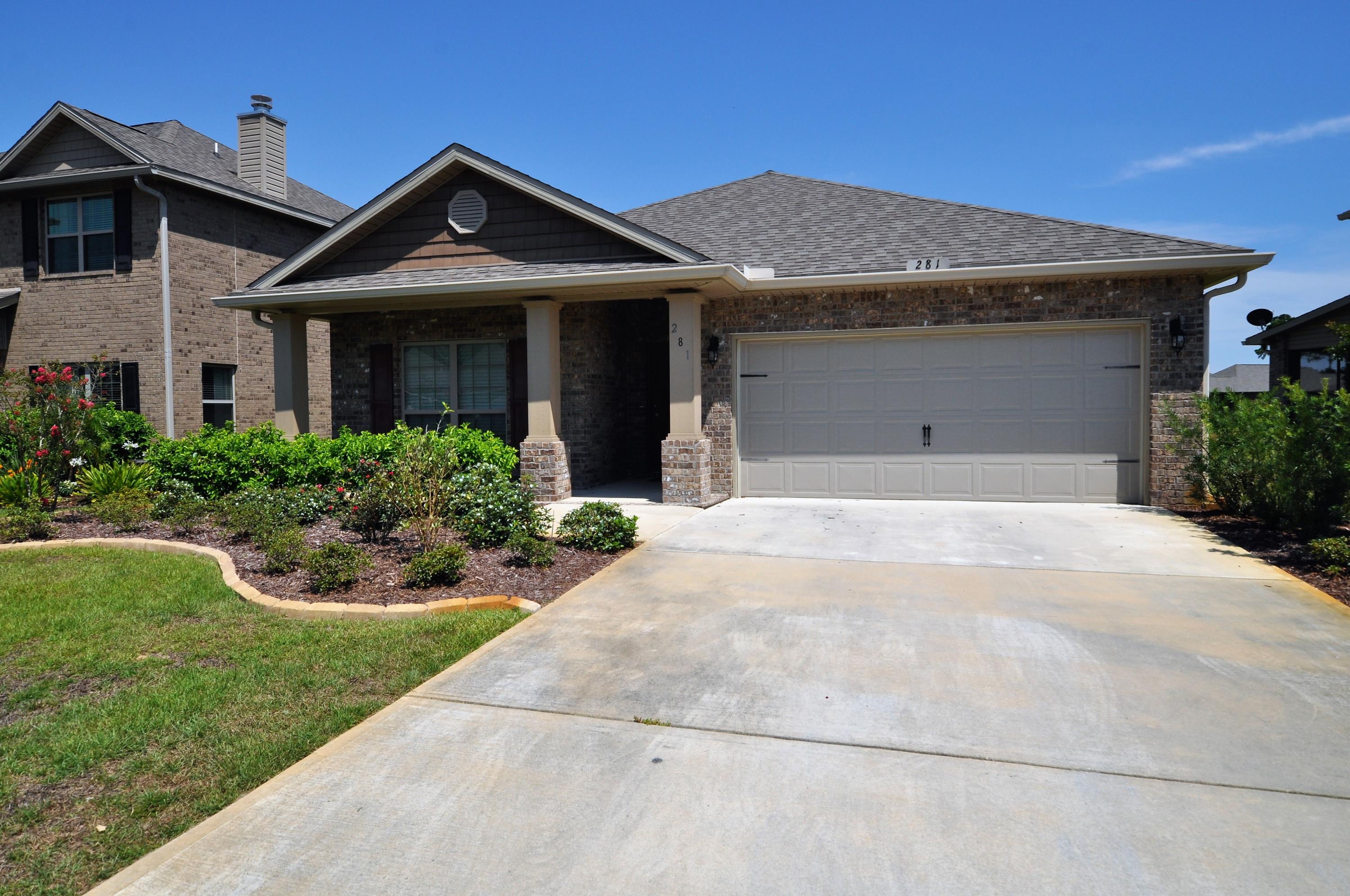 281 Pin Oak Loop Santa Rosa Beach, FL 32459 - Photo 4 of 21 a front view of a house with a yard