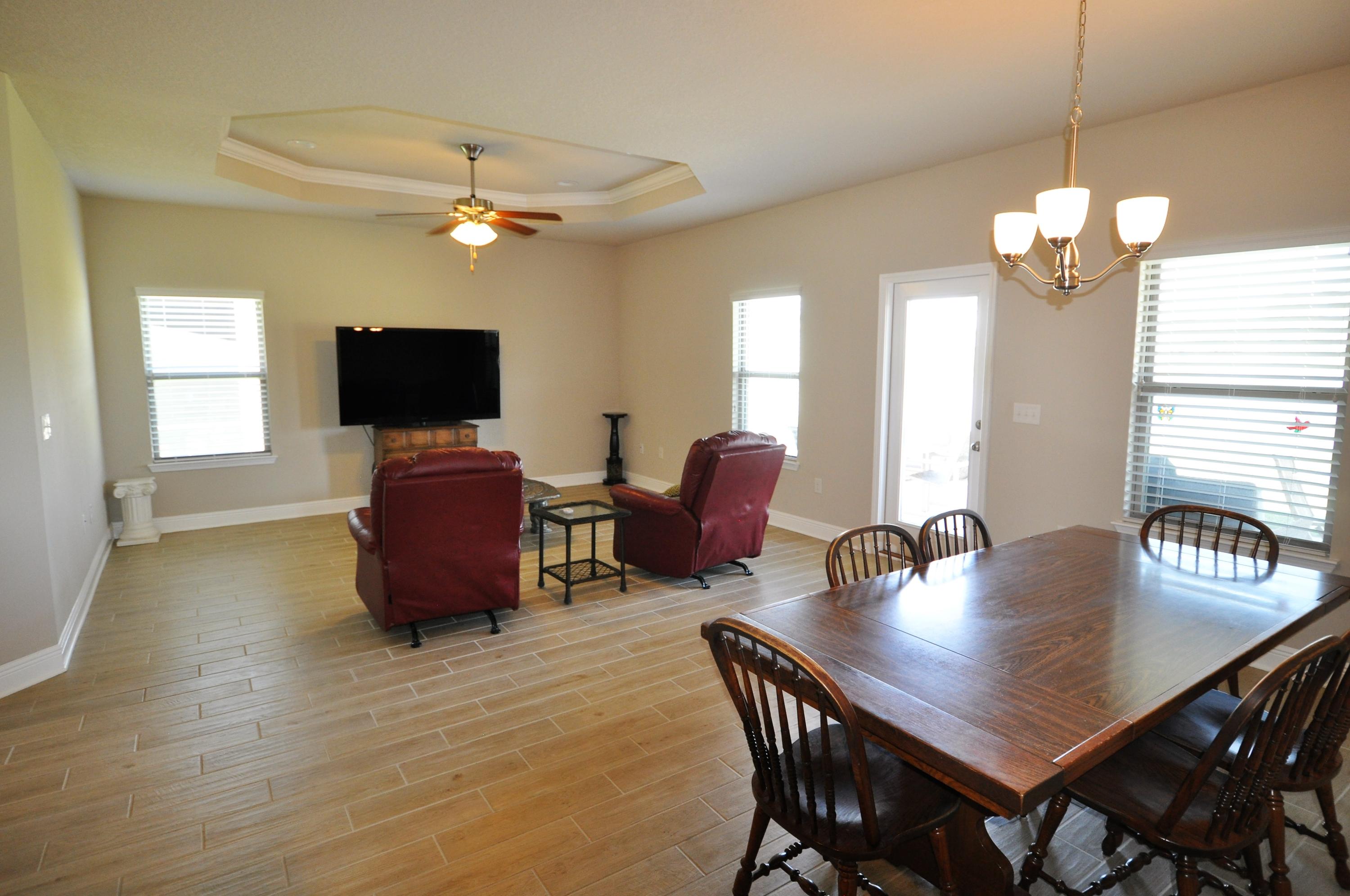 281 Pin Oak Loop Santa Rosa Beach, FL 32459 - Photo 7 of 21 a view of a dining room with furniture window and wooden floor