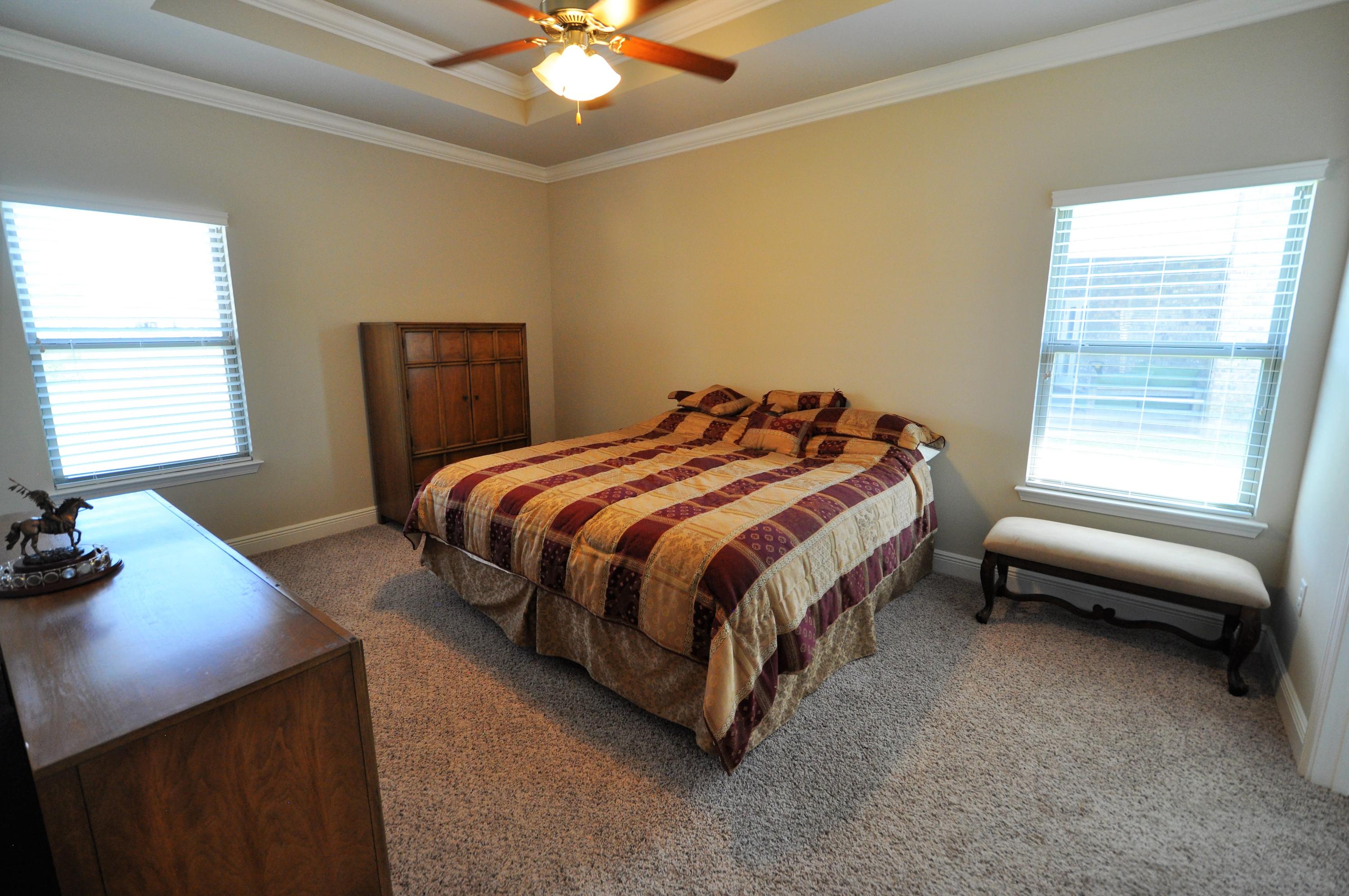 281 Pin Oak Loop Santa Rosa Beach, FL 32459 - Photo 9 of 21 a bedroom with a bed and a chandelier