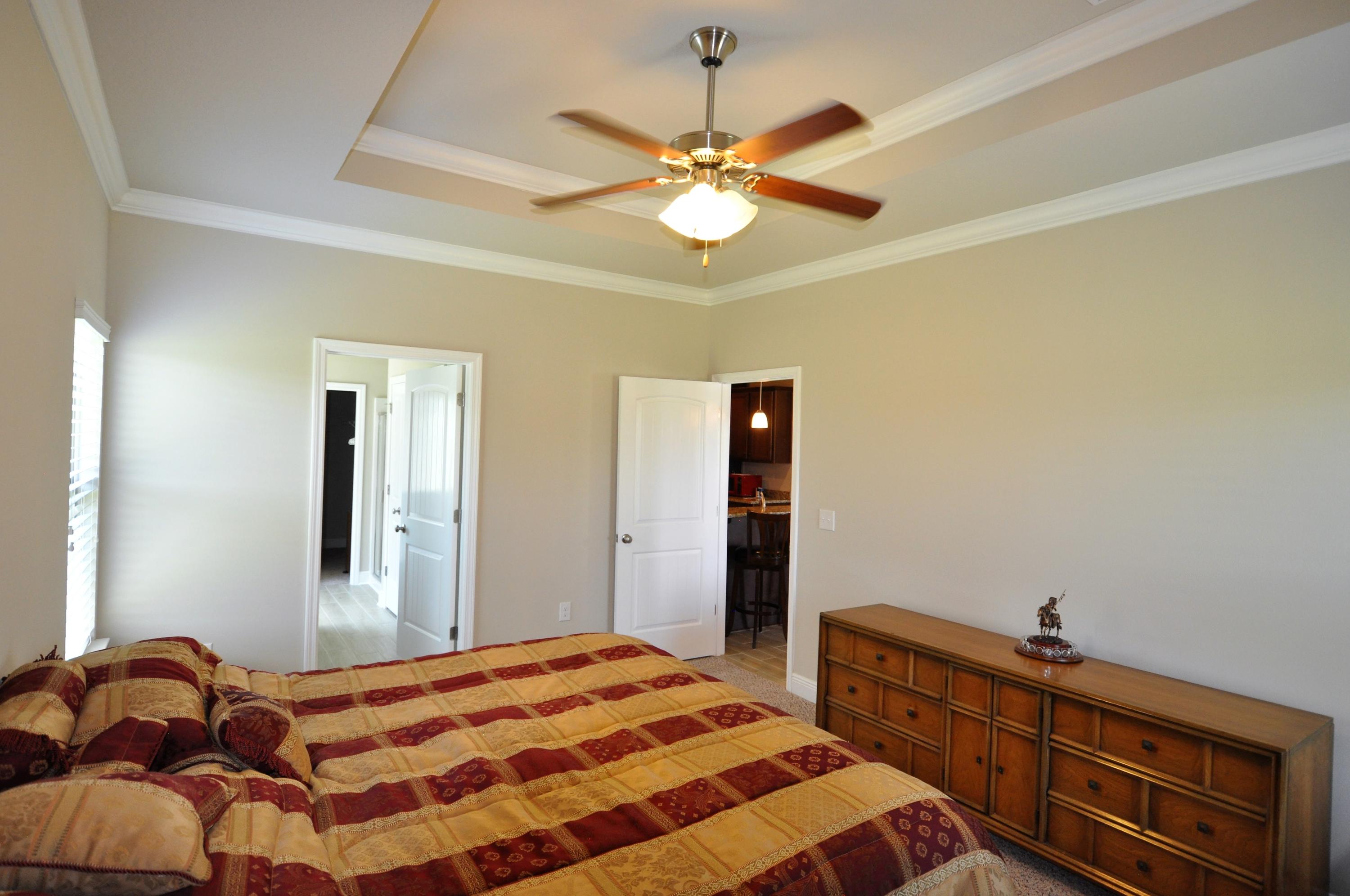 281 Pin Oak Loop Santa Rosa Beach, FL 32459 - Photo 10 of 21 a bedroom with a bed and a chandelier