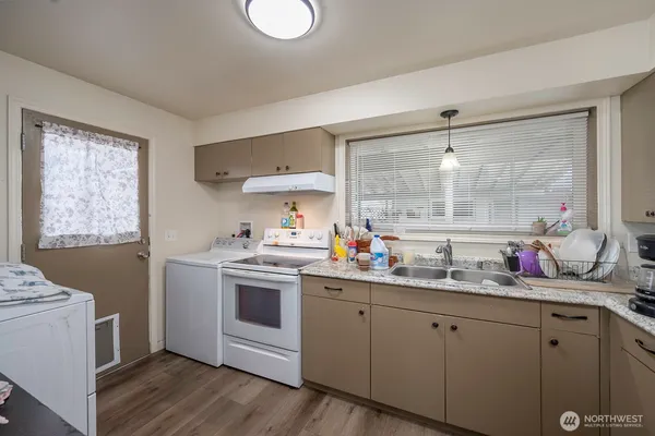 a kitchen with a sink stove and cabinets