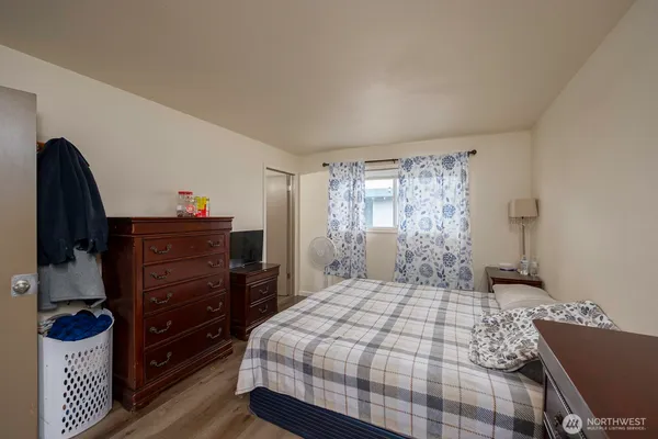 a bedroom with a bed and a dresser