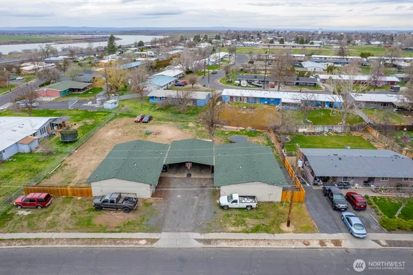 an aerial view of a house with a swimming pool yard and mountain view in back