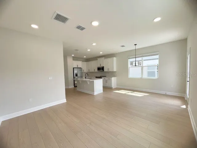 a view of a kitchen with a sink and dishwasher cabinets