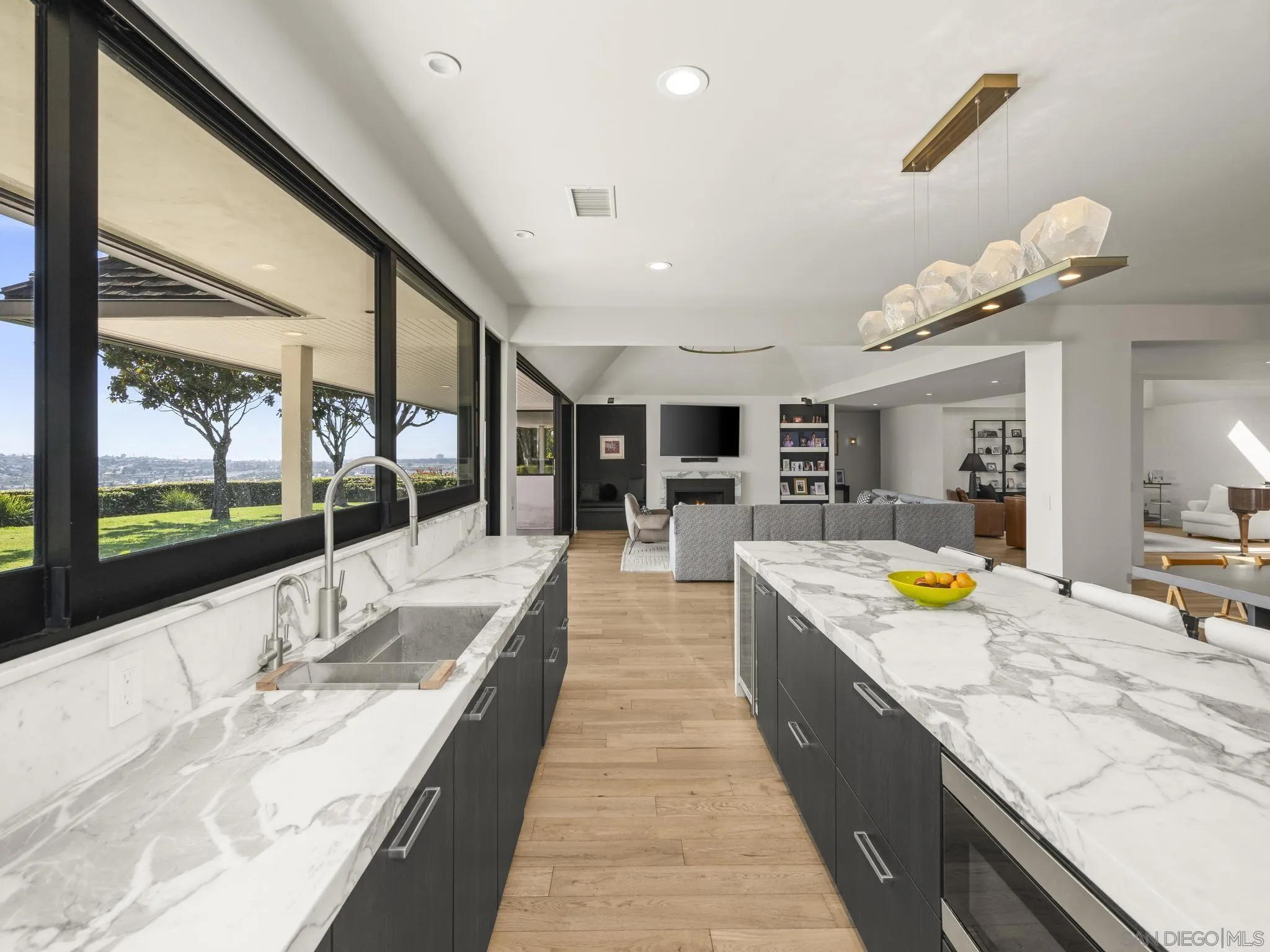 2323 San Juan Road San Diego, CA 92103 - Photo 6 of 47 a large kitchen with kitchen island a counter space a sink a stove and living area view