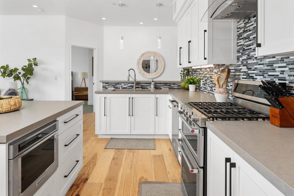 5656 La Jolla Boulevard, Unit 3 La Jolla, CA 92037 - Photo 12 of 35 a kitchen with granite countertop stainless steel appliances and white cabinets
