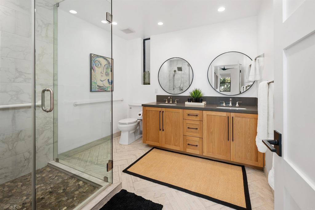 5656 La Jolla Boulevard, Unit 3 La Jolla, CA 92037 - Photo 19 of 35 a room with wooden cabinets and clock on the wall