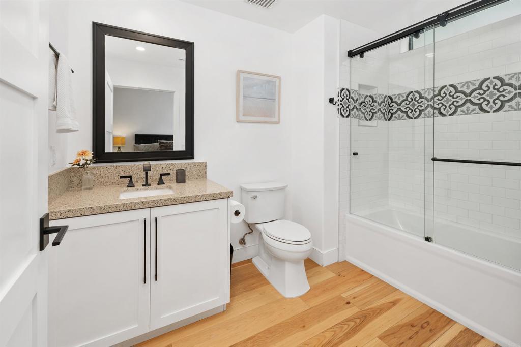 5656 La Jolla Boulevard, Unit 3 La Jolla, CA 92037 - Photo 23 of 35 a bathroom with a sink toilet a mirror and shower