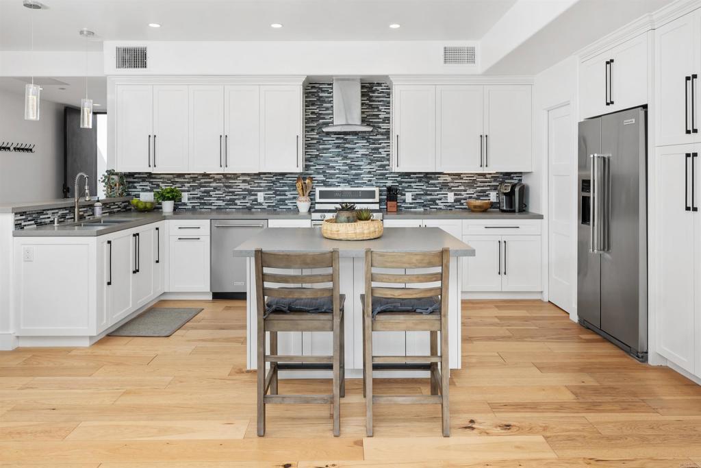 5656 La Jolla Boulevard, Unit 3 La Jolla, CA 92037 - Photo 10 of 35 a kitchen with granite countertop cabinets and stainless steel appliances