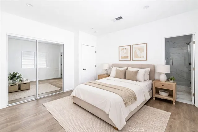 a bedroom with a bed and glass door