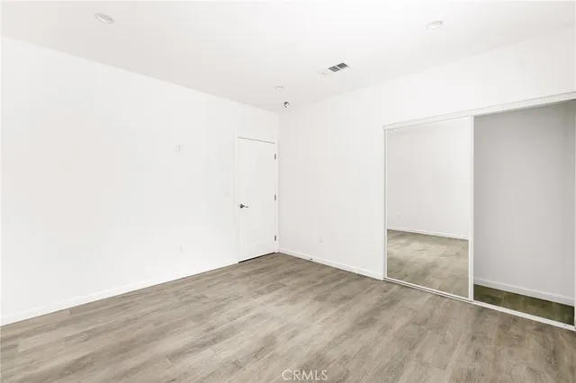 an empty room with wooden floor