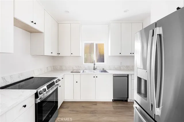 a kitchen with a sink stove and refrigerator