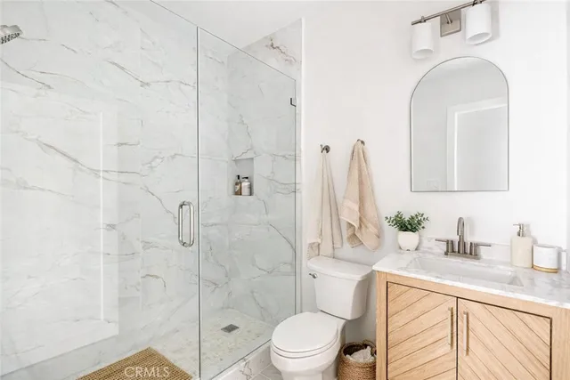 a bathroom with a toilet sink and shower