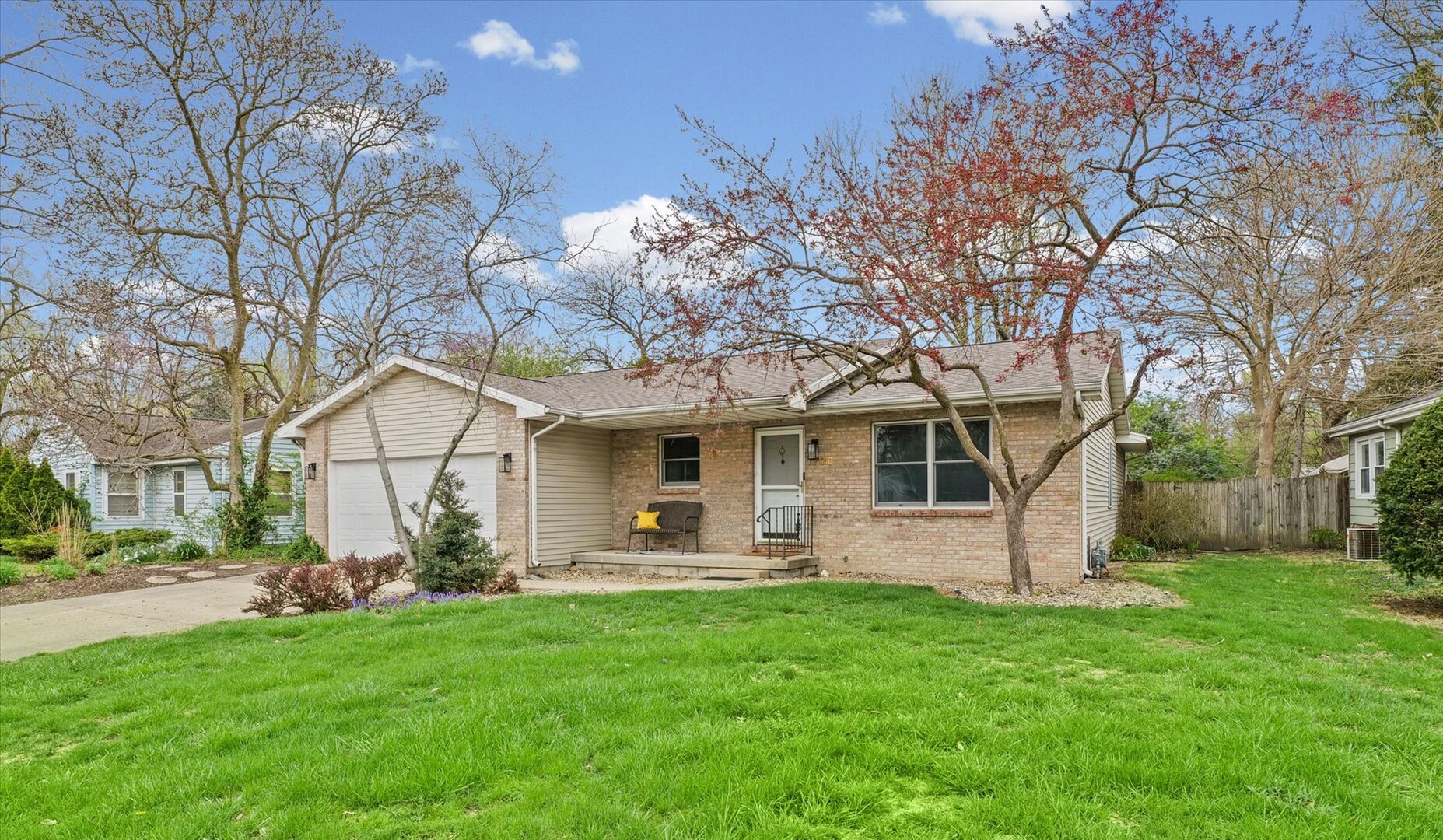 a front view of house with yard and green space