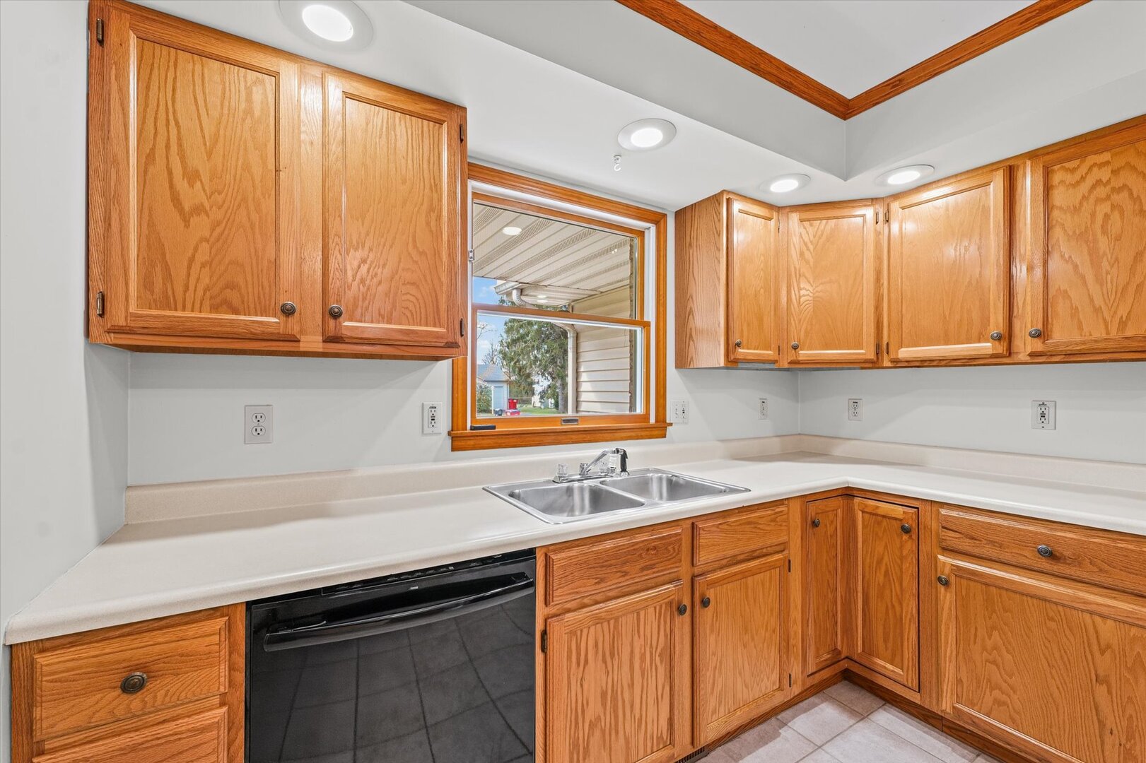 1706 Chevy Chase Drive Champaign, IL 61821 - Photo 22 of 29 a kitchen with stainless steel appliances granite countertop white cabinets sink and window