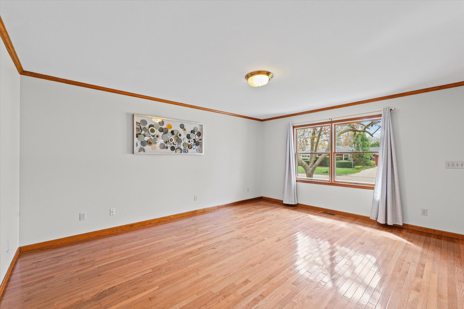 1706 Chevy Chase Drive Champaign, IL 61821 - Photo 25 of 29 a view of an empty room with a window and a wooden floor