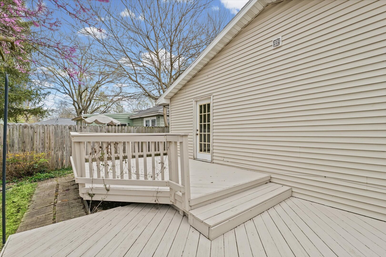 1706 Chevy Chase Drive Champaign, IL 61821 - Photo 4 of 29 a view of deck with a table and chairs and wooden floor