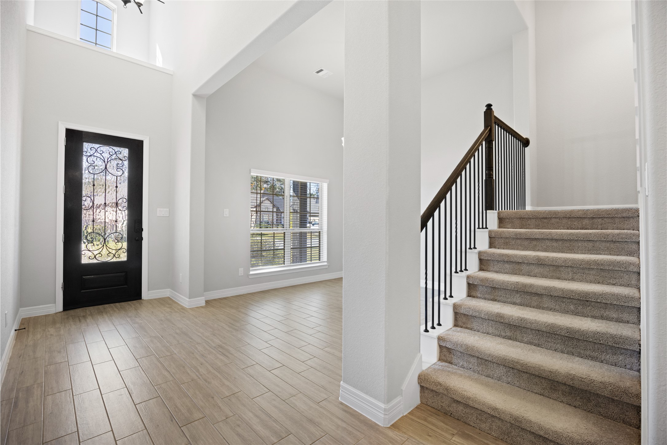 108 Yellow Perch Way Conroe, TX 77318 - Photo 8 of 50 a view of an entryway with wooden floor and door
