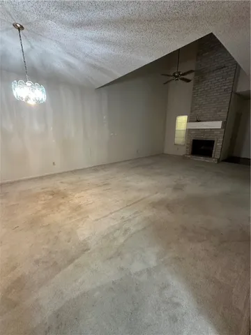 a view of empty room with a fireplace