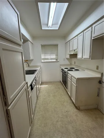 a utility room with cabinets dryer and washer