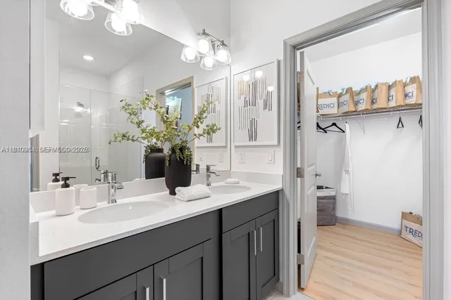 a bathroom with a sink double vanity and a mirror