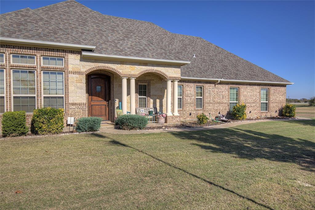 1066 Canyon Lake Road Wills Point, TX 75169 - Photo 32 of 40 a front view of a house with garden