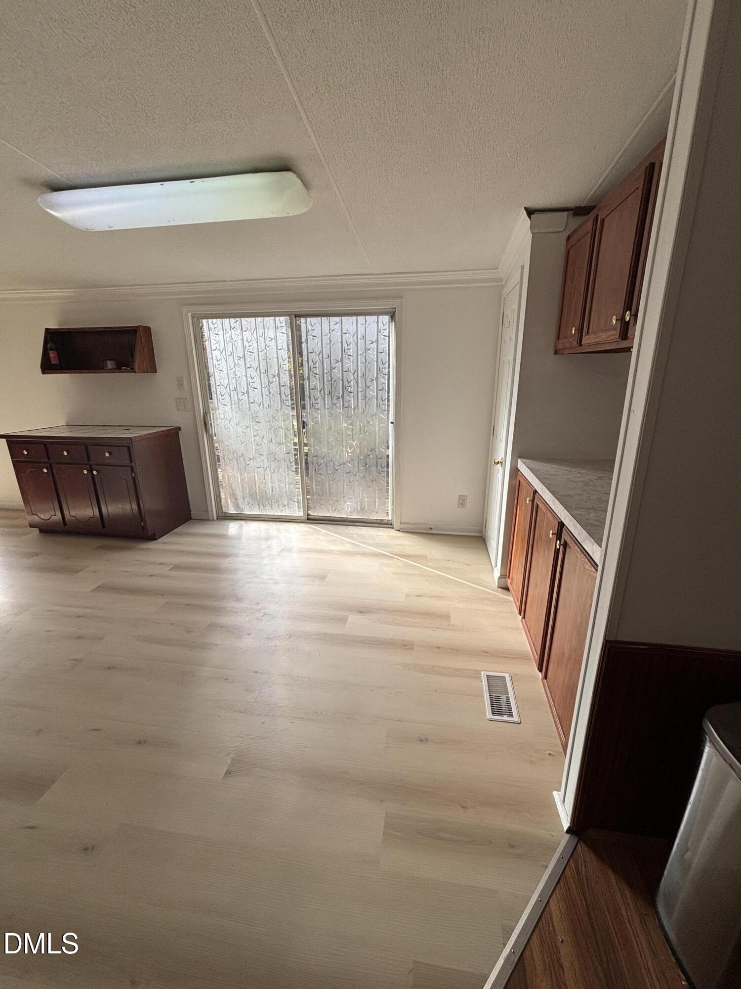 762 Shocco Springs Road Warrenton, NC 27589 - Photo 13 of 24 a view of an empty room with wooden floor and a window