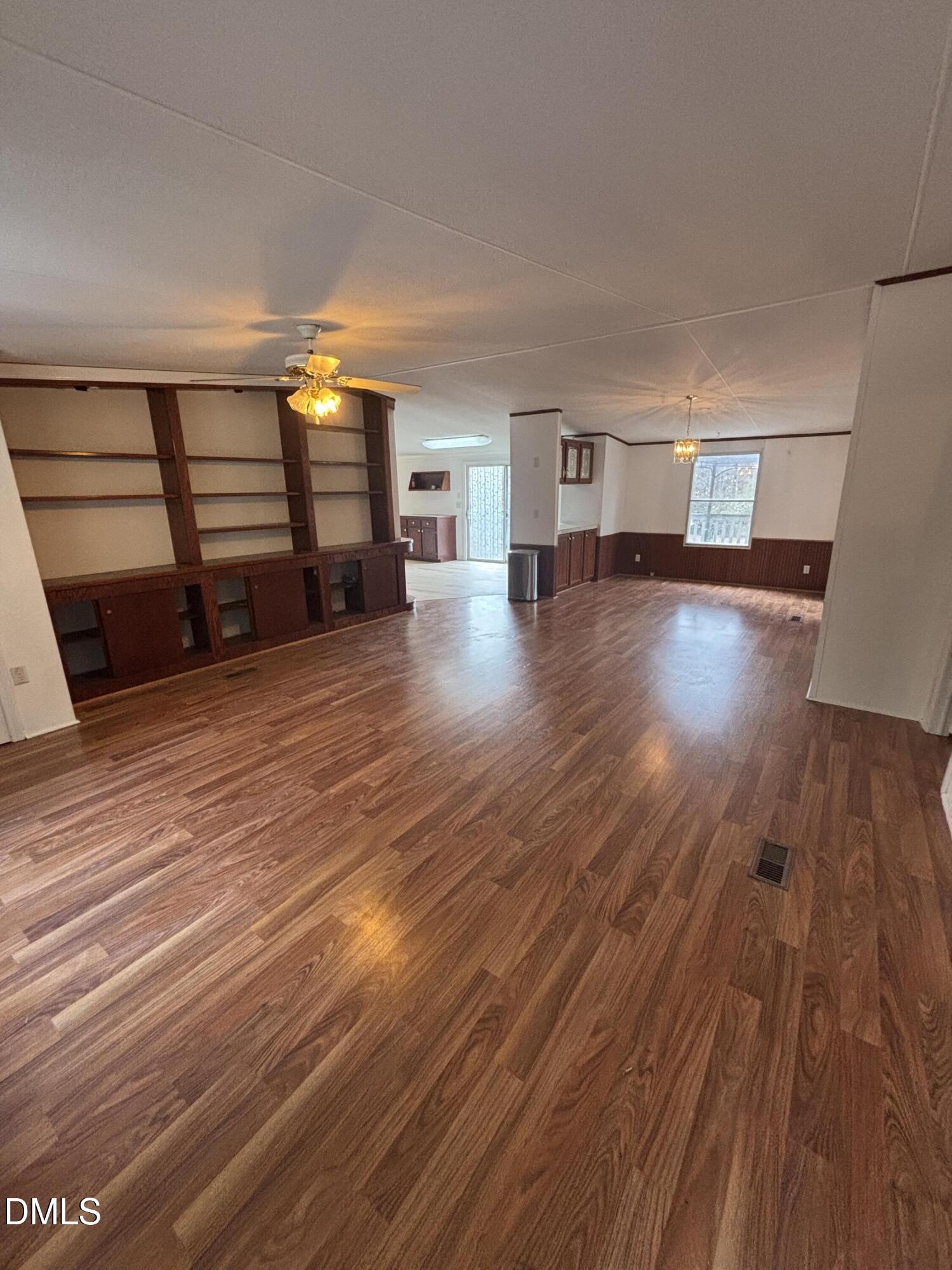 762 Shocco Springs Road Warrenton, NC 27589 - Photo 7 of 24 a view of empty room with stairs and wooden floor