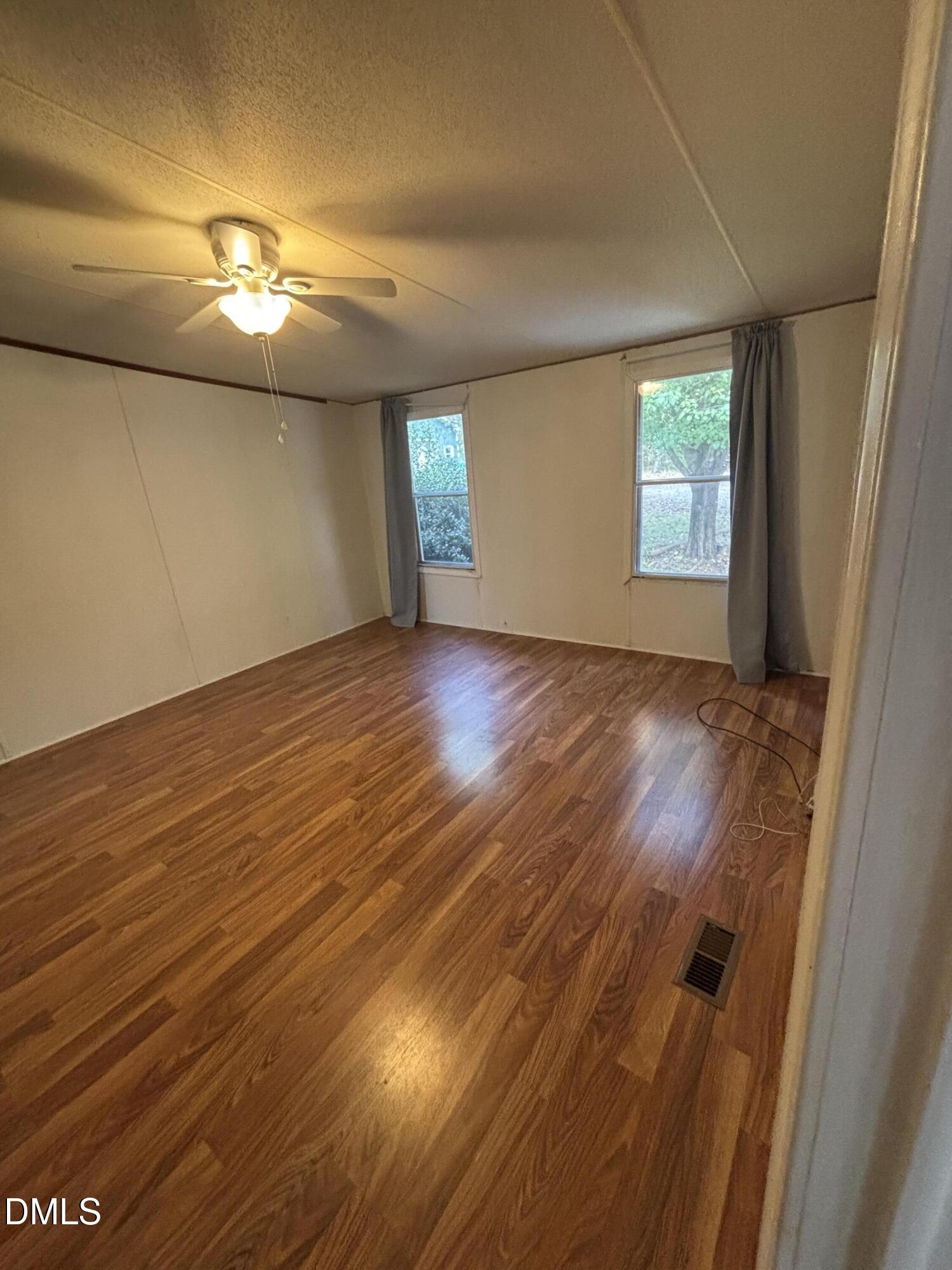 762 Shocco Springs Road Warrenton, NC 27589 - Photo 10 of 24 an empty room with wooden floor and windows