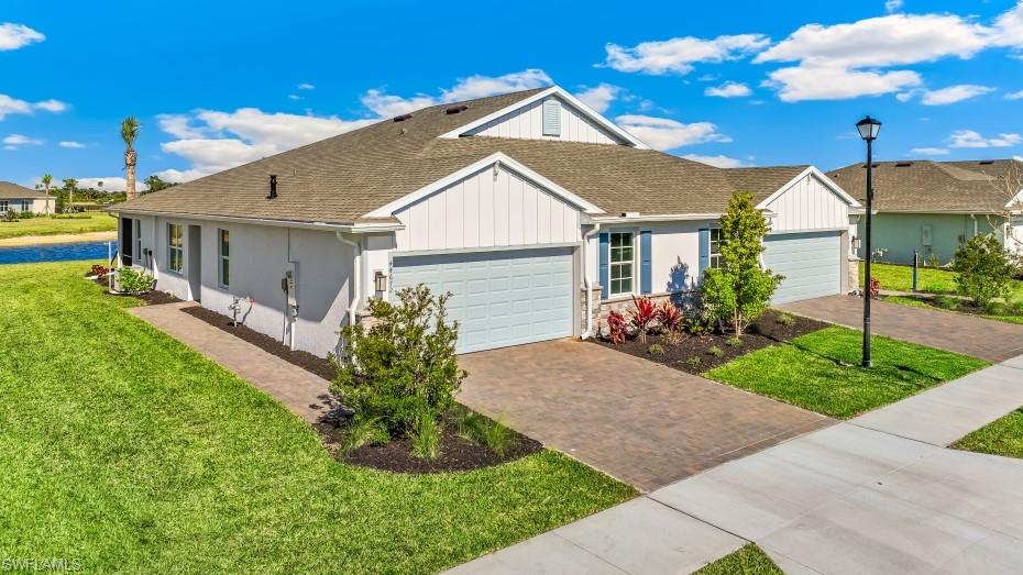 17637 Shade Tree Loop Punta Gorda, FL 33982 - Photo 2 of 35 Model home - Modern stucco exterior with board and batten accents