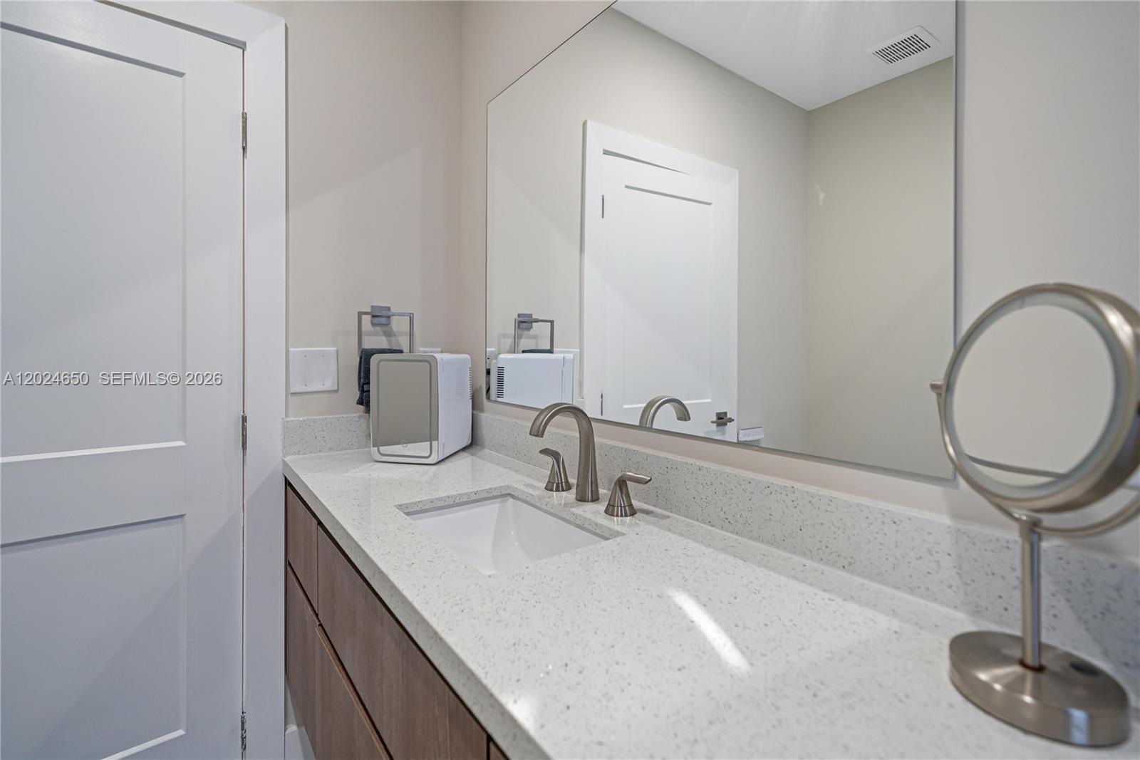 1663 Southwest 13th Street Miami, FL 33145 - Photo 31 of 112 a bathroom with a sink a toilet and a mirror