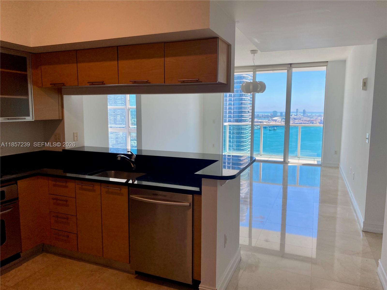 31 Southeast 5th Street, Unit 3912 Miami, FL 33131 - Photo 2 of 13 a kitchen with a sink and cabinets