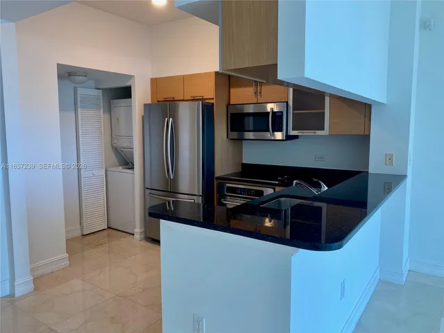 a kitchen with stainless steel appliances a refrigerator and a stove