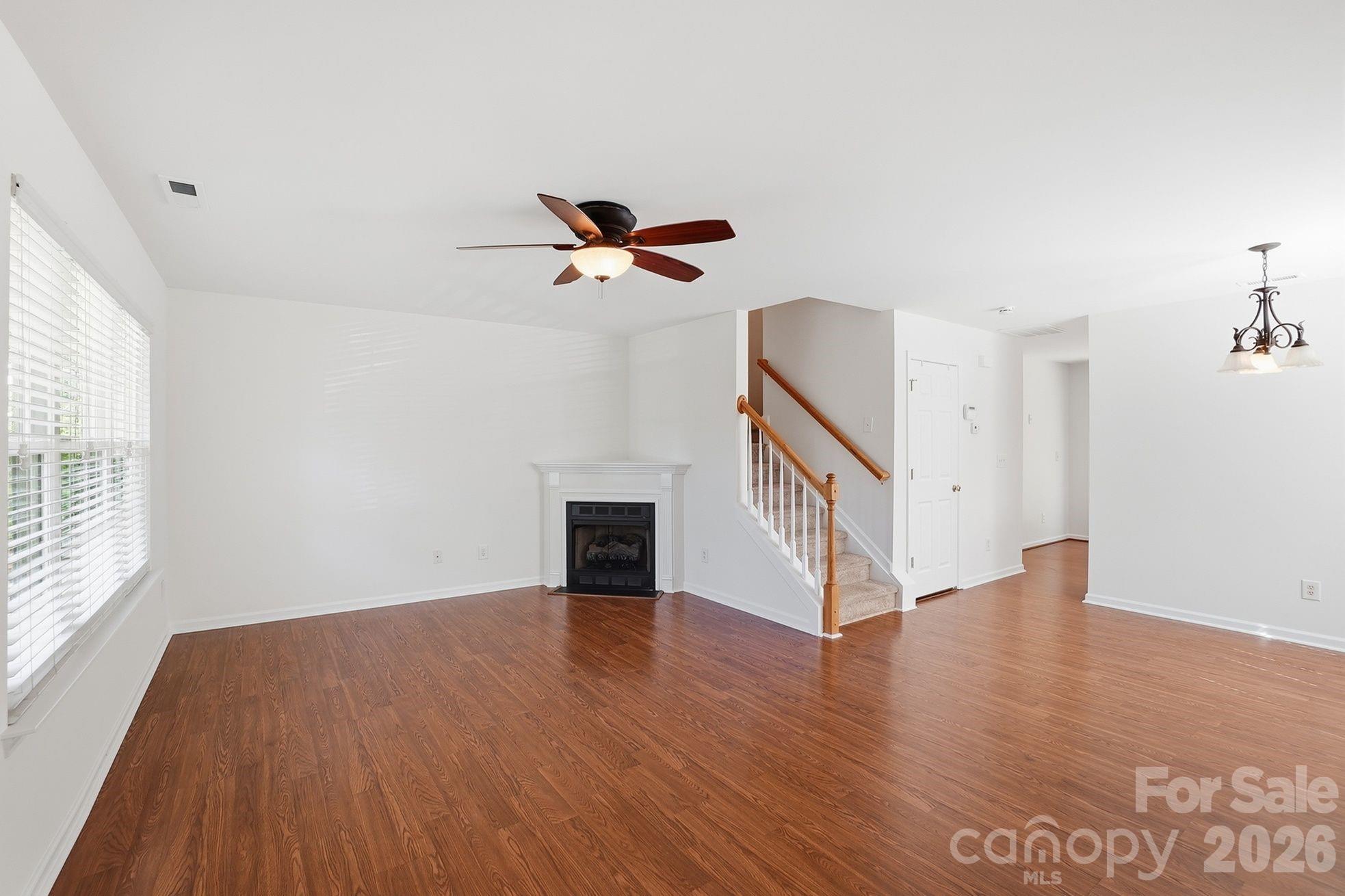 322 Deep Water Lane Fort Mill, SC 29715 - Photo 4 of 29 a view of an empty room with wooden floor and a window