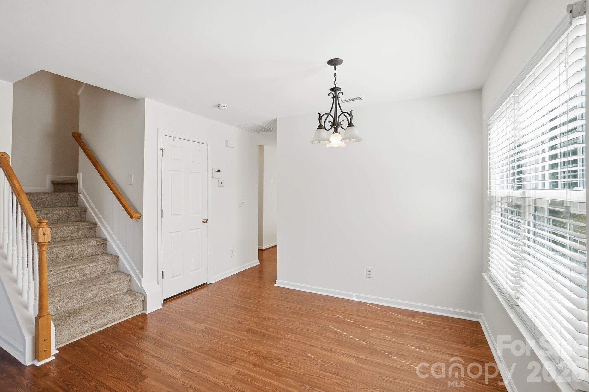 322 Deep Water Lane Fort Mill, SC 29715 - Photo 5 of 29 a view of a hallway with wooden floor and staircase