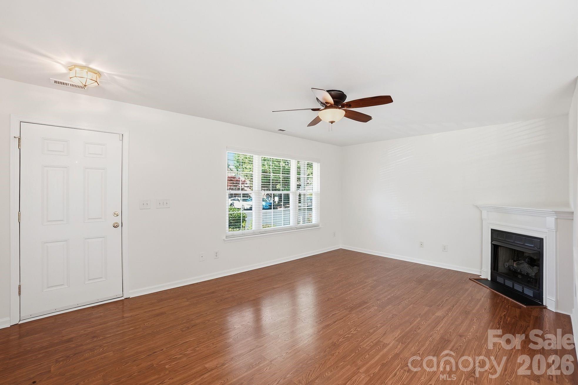 322 Deep Water Lane Fort Mill, SC 29715 - Photo 8 of 29 wooden floor in an empty room with a window