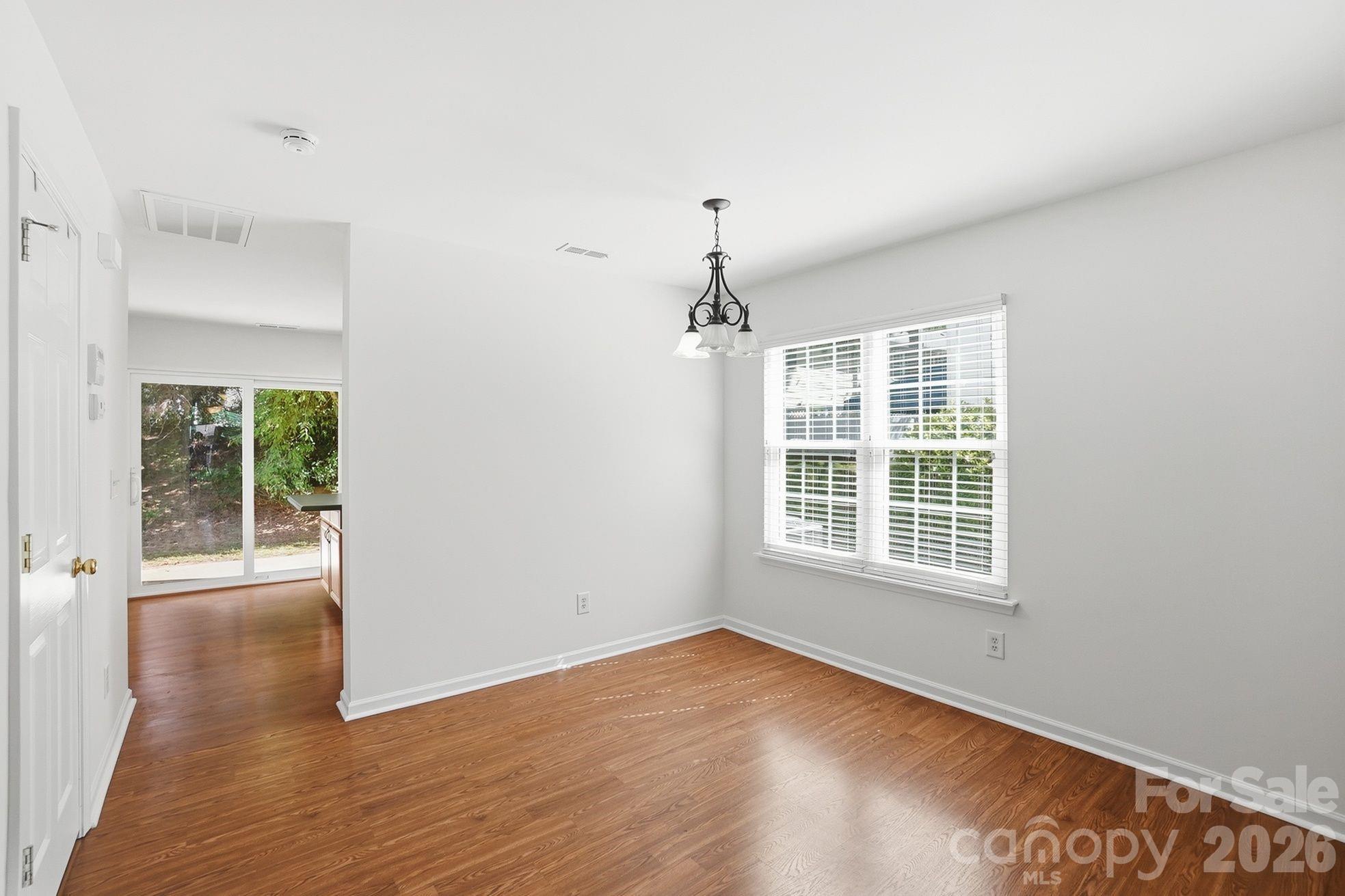 322 Deep Water Lane Fort Mill, SC 29715 - Photo 10 of 29 a view of an empty room with wooden floor and a window