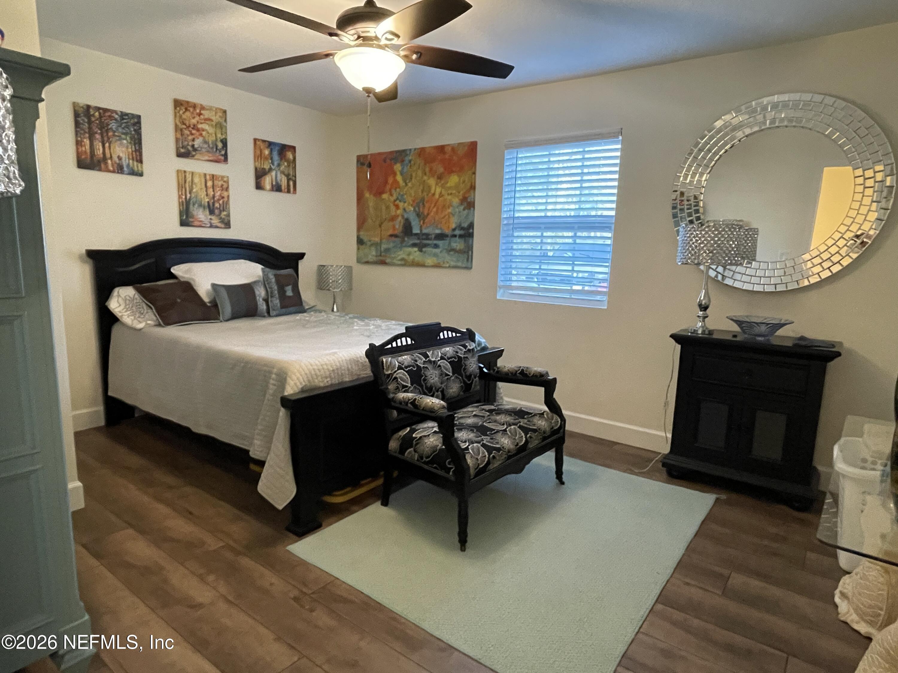 4055 Dimsdale Road Jacksonville, FL 32257 - Photo 8 of 15 a bedroom with a bed chair and a fireplace