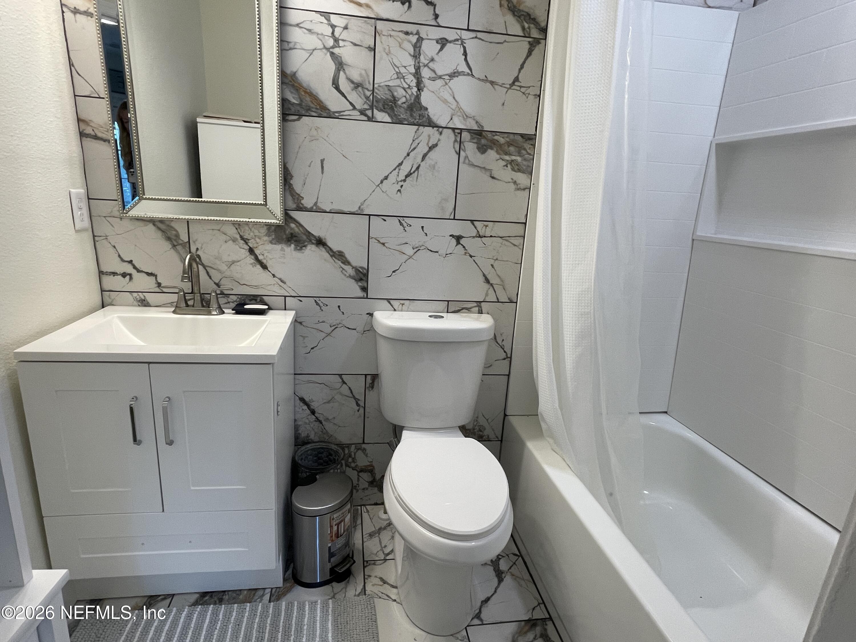 4055 Dimsdale Road Jacksonville, FL 32257 - Photo 10 of 15 a white toilet sitting next to a bathroom sink