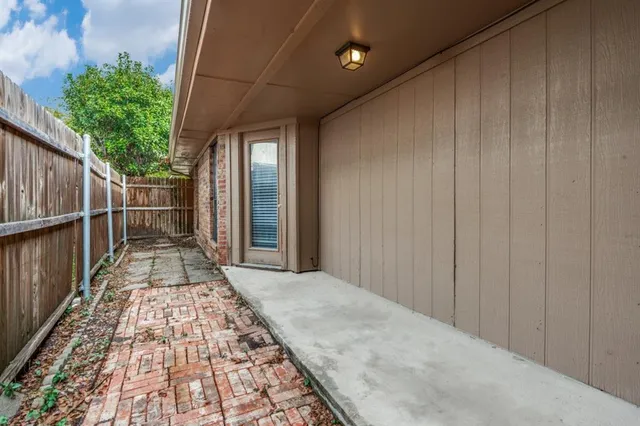 a view of a pathway with a wooden fence